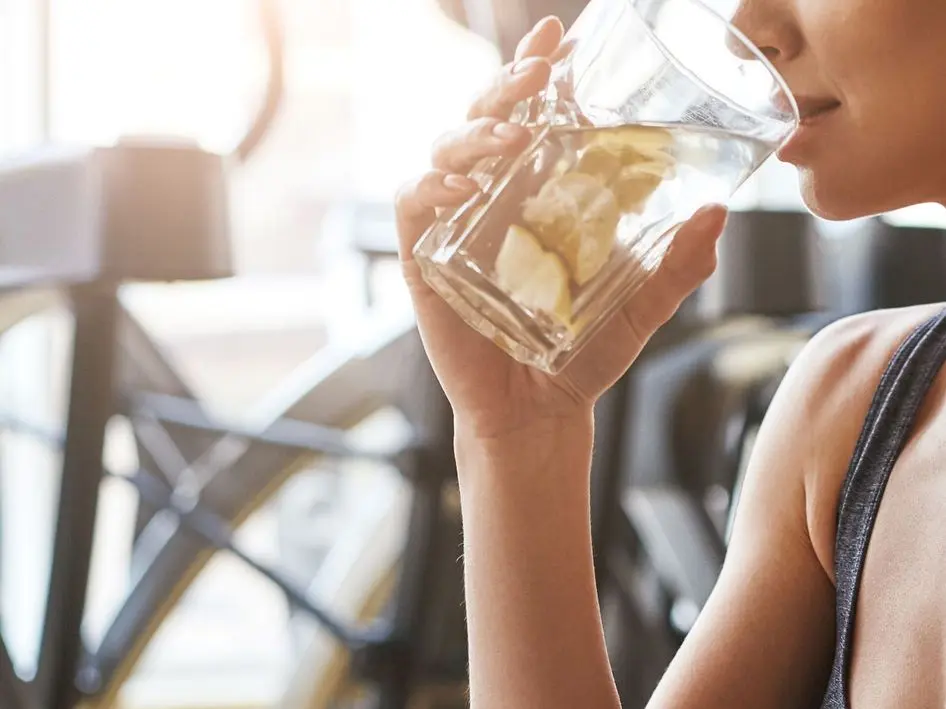 Woman drinking cleartide water.