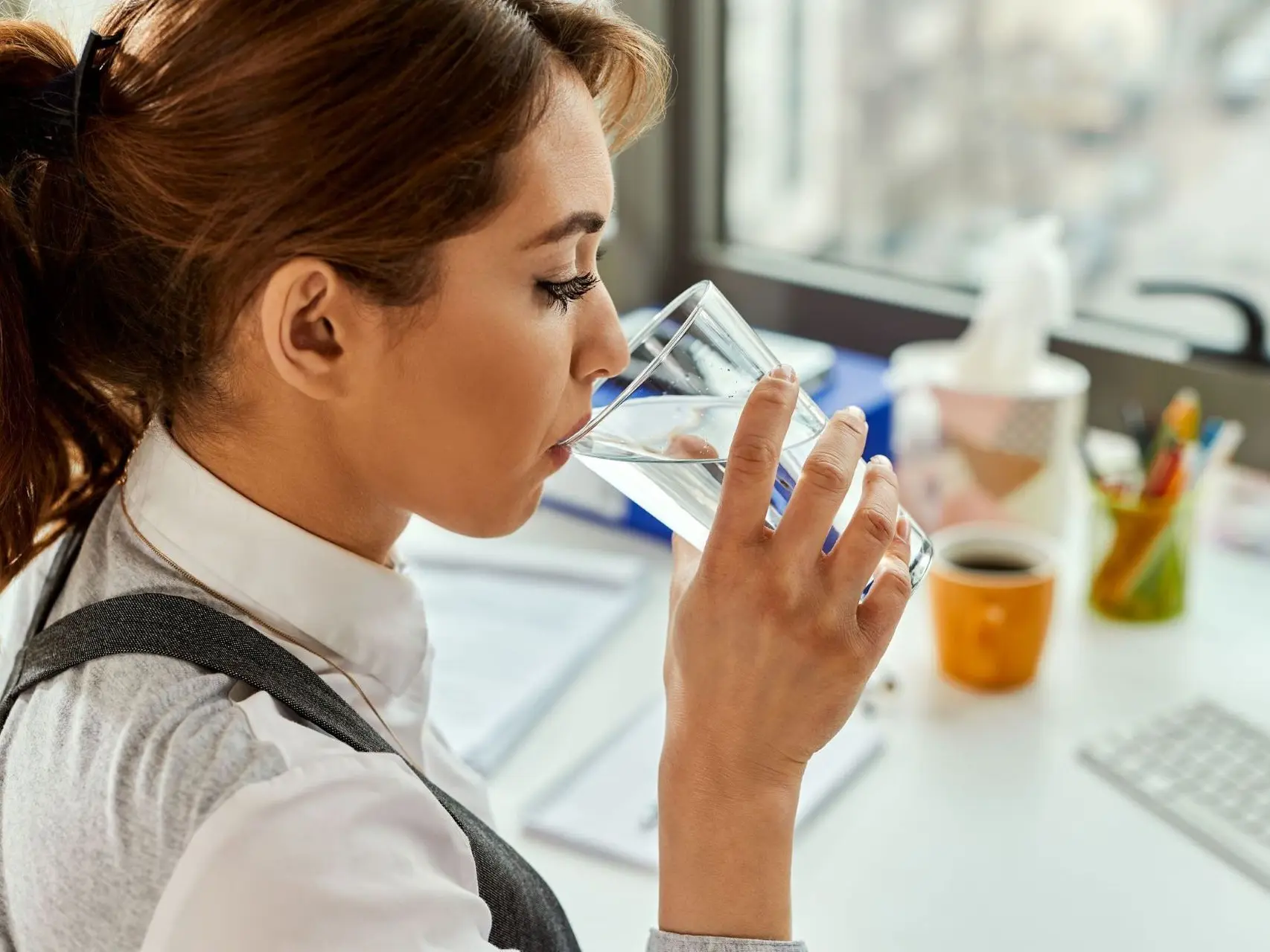 Woman drinking Cleartide Hydration Systems Water.