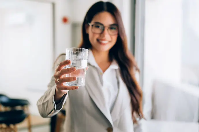 Woman at work with a glass of water. Woman at work with a glass of water.